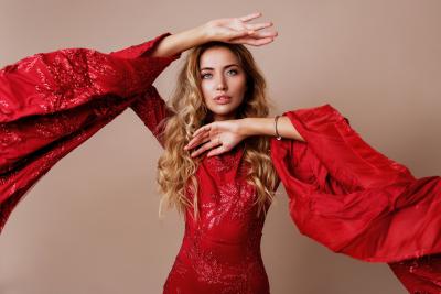 Young Blond Lovely Woman Luxurious Red Dress With Wide Sleeves Expressive Pose